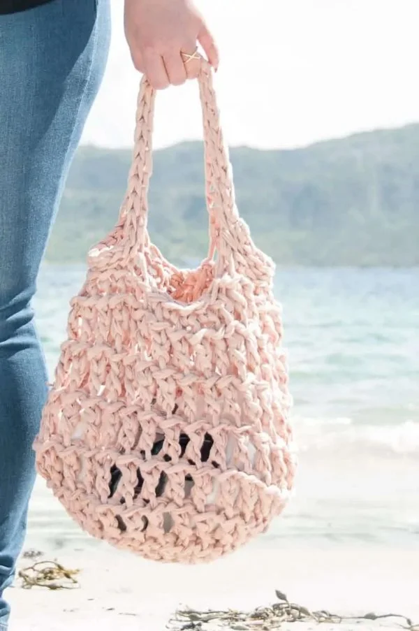 A chunly crochet mesh beach bag.