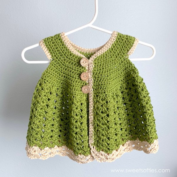 Green crochet dress with lacy stitch pattern.
