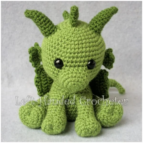 A green baby dragon amigurumi.