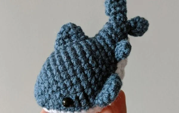 A dark blue crochet shark.