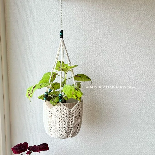 A crochet plant hanger with bead detail.