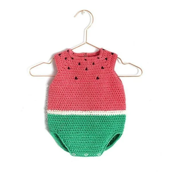 A watermelon-styled crochet baby romper on a hanger.