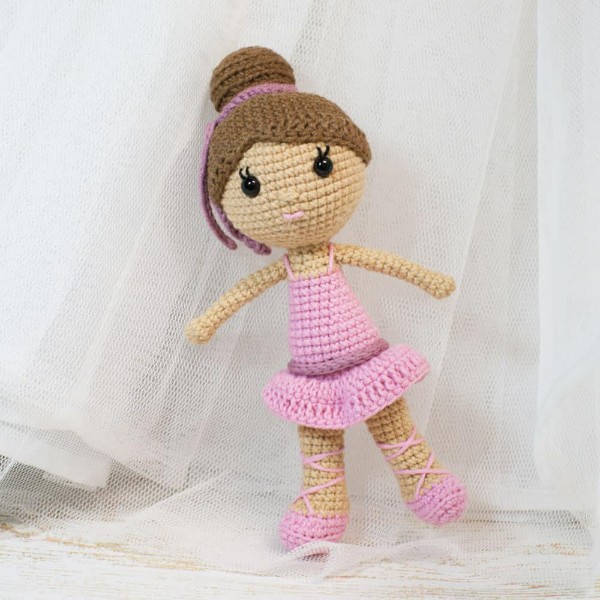 A crochet ballerina doll in a pink tutu and ballet shoes.