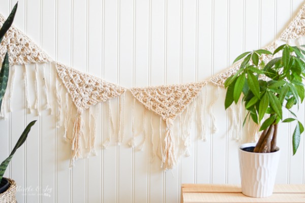 A natural coloured boho crochet garland with tassels.