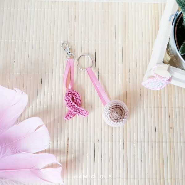 Two crochet keychains for breast cancer awareness.