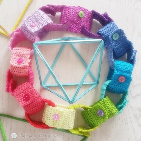 A crochet paper chain in rainbow colours.