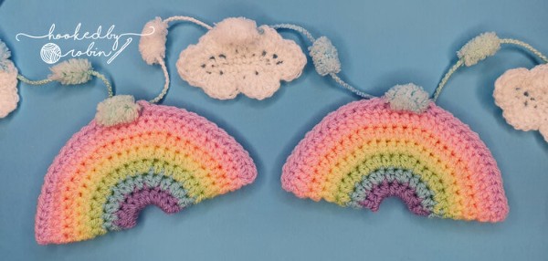 A crochet garland with rainbow and cloud motifs.