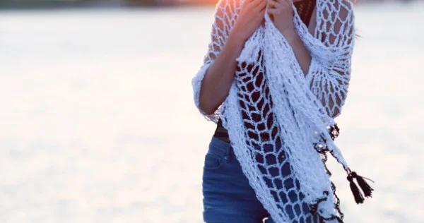 A woman wearing a white crochet sarong.