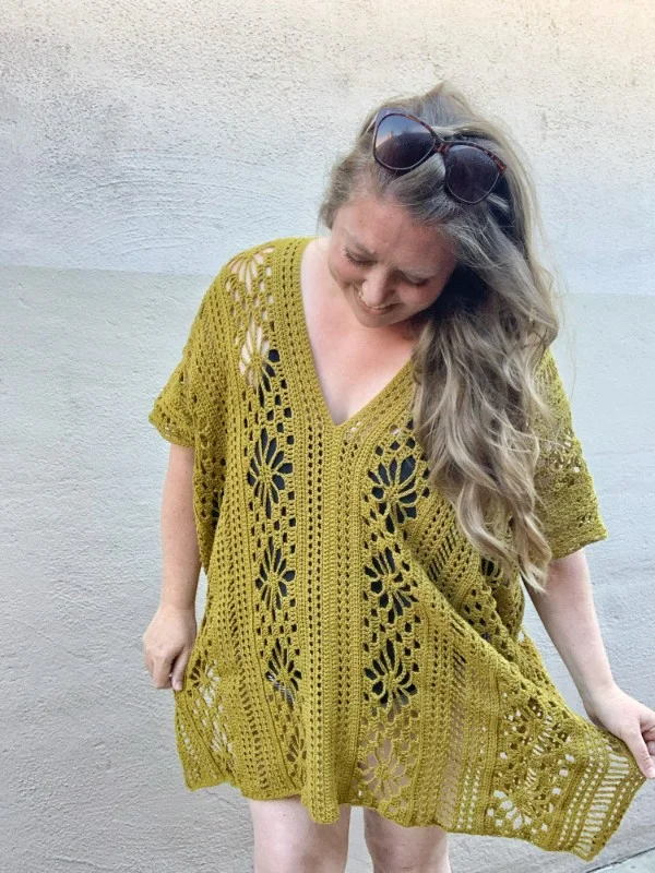 A woman weraing a lacy crochet cover-up.