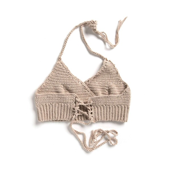 An ecru coloured crochet bralette on a white background.
