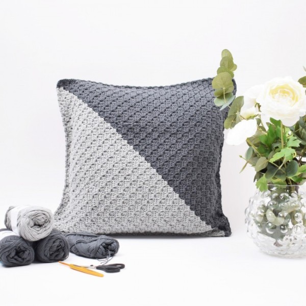 A two-toned grey corner-to-corner crochet cushion.