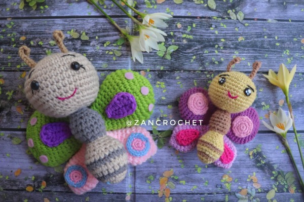 Two amigurumi crochet butterflies in bright colours.