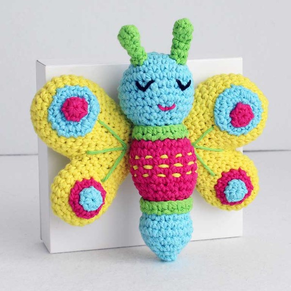 A cute and colourful crochet butterfly plushie.