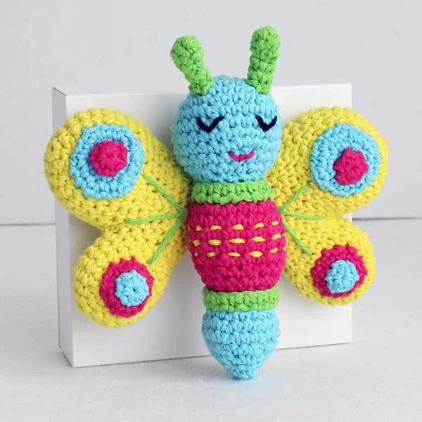 A cute and colourful crochet butterfly plushie.