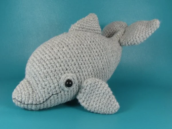 A grey bottle-nosed dolphin amigurumi toy.