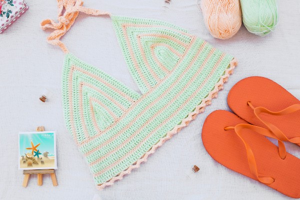 A green and pink striped crochet bralette.