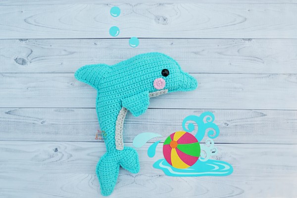 A cuddly crochet dolphin softie toy.