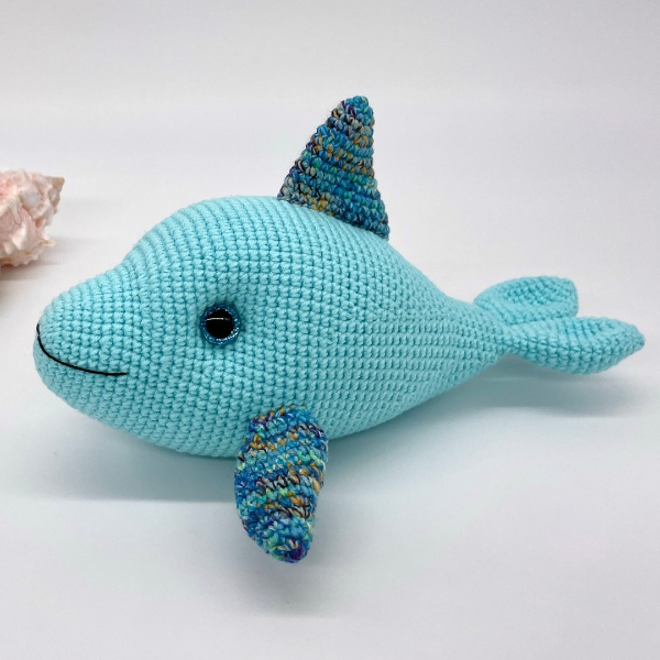 Two-toned crochet dolphin softie toy.