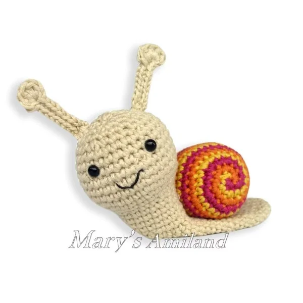 An orange and white amigurumi snail.