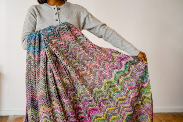 Tunisian crochet ripple blanket in variegated yarn.
