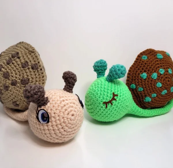 Two big crochet snail toys.