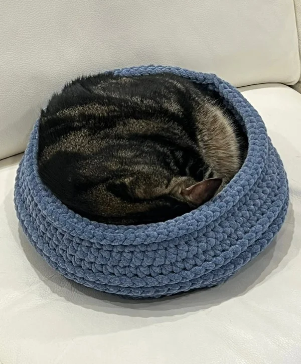 A blue crochet cat ped with deep sides.