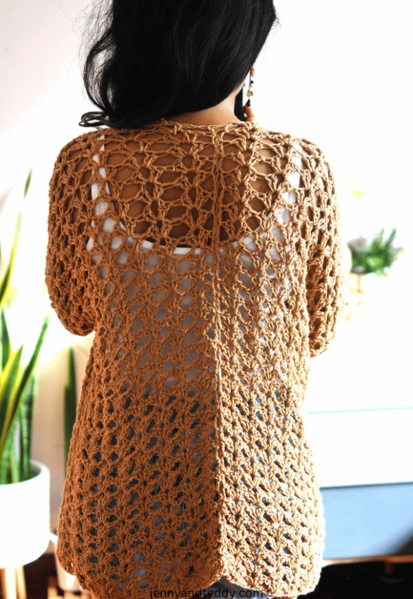 Back view of a woman wearing a lacy crochet summer cardigan.