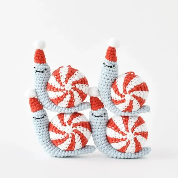 Four crochet snails with peppermint candy shell.