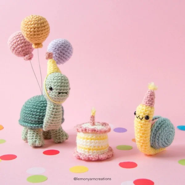 Brthday themed crochet snail, turtle, and cake.