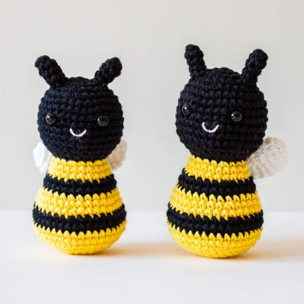 Two standing crochet bees with black faces.