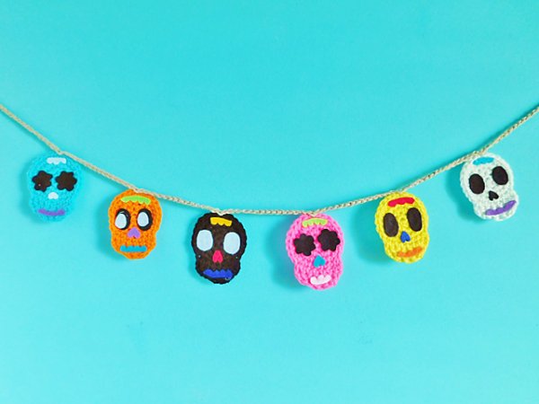 Brightly coloured crochet skull garland.