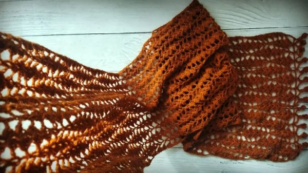 An autumn coloured lace crochet scarf.
