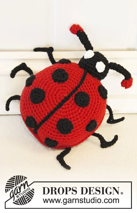 A top-view of a crochet ladybug.