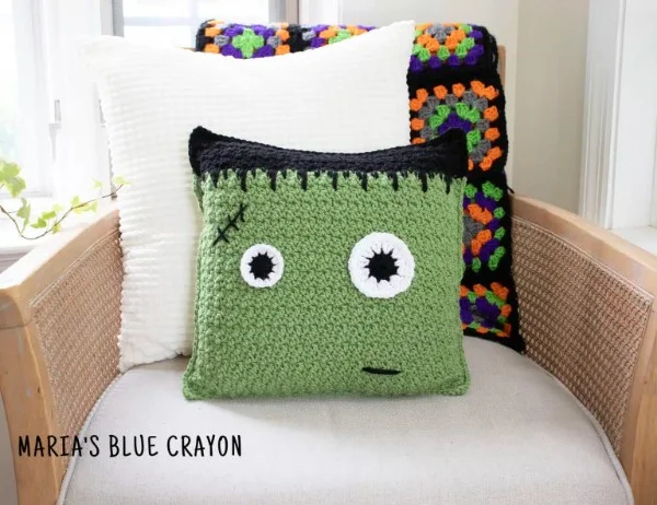 A frankenstein crochet halloween pillow.