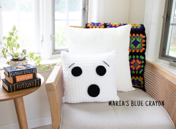 A crochet Halloween ghost pillow.