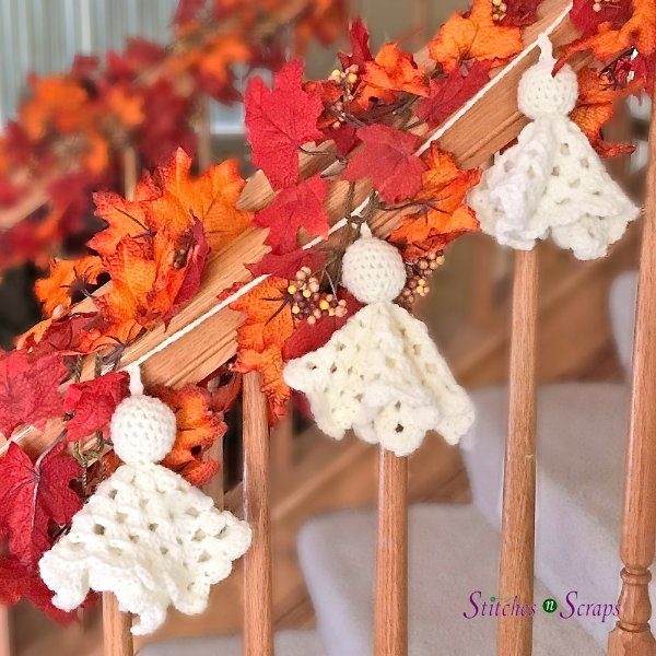 A crochet ghost garland draped along a bannister.