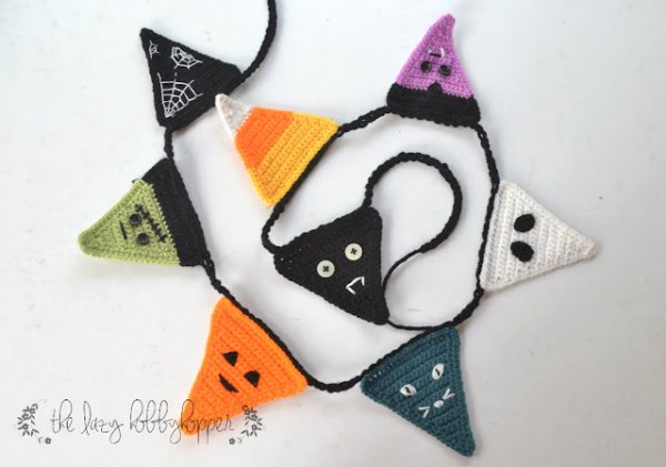 A crochet Halloween bunting draped loosely.