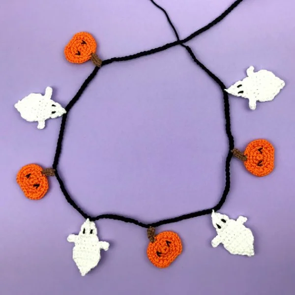 A ghost and pumpkin crochet Halloween garland.