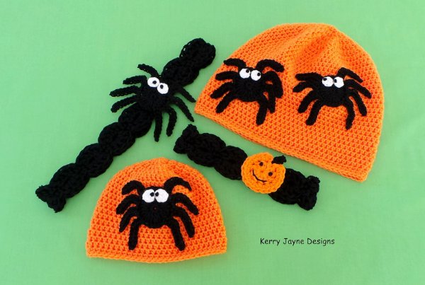 Two orange crochet beanies with spider appliques.