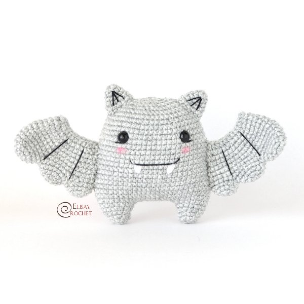 A crochet bat toy with cute fangs on a white background.