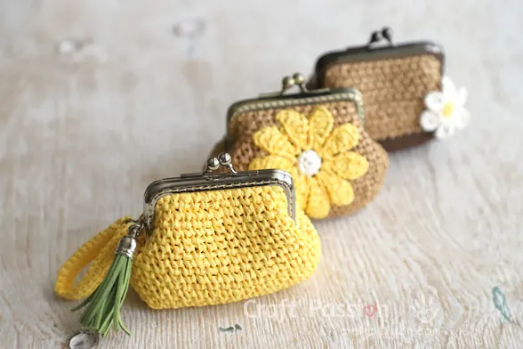 Three raffia crochet coin purses in a row,