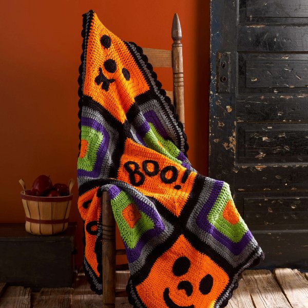 A Halloween-themed crochet granny square blanket.