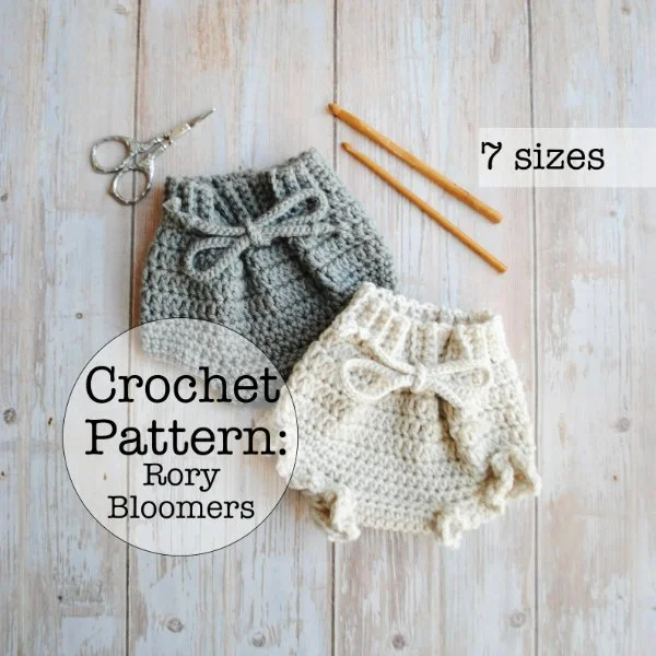 Two crochet baby bloomer, one white and one blue.