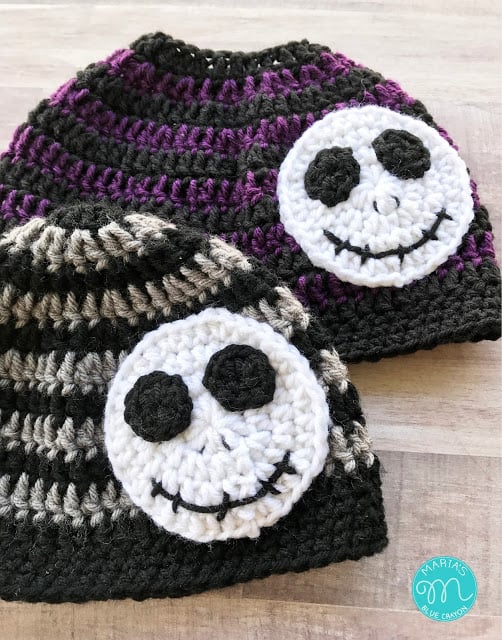 Two striped crochet hats with skeleton applique.
