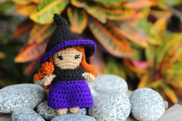 A small purple crochet witch.