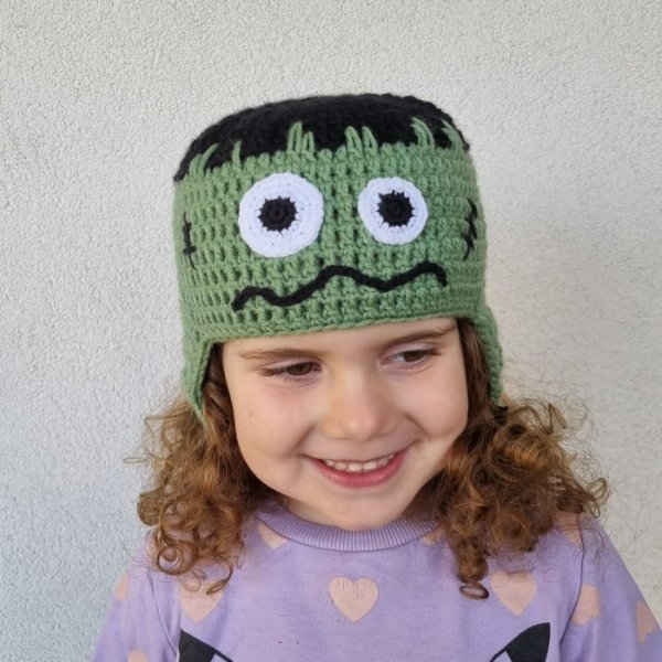 A child wearing a zombie crochet hat.