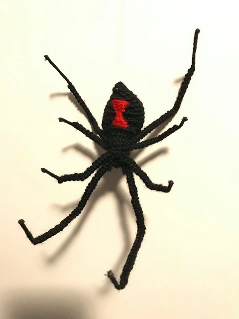 A realisttic looking crochet black widow spider.