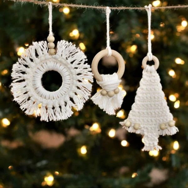 Three white with timber accents,boho-style crochet Christams Tree ornaments.