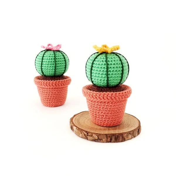Two crochet cacti in miniature crochet teracotta plant pots.