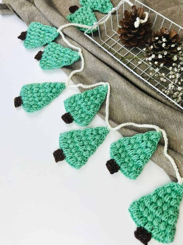 A crochet gatland with Puff Stitch Christmas trees.
